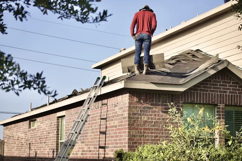 Professional roofer working on a residential roof in President Country Club